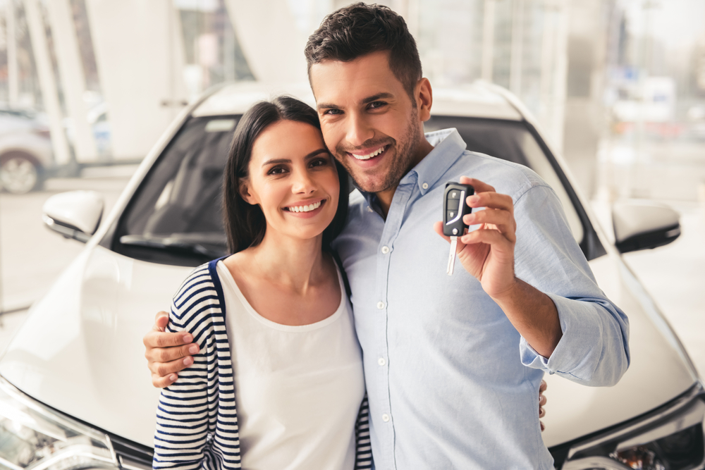 Visiting,Car,Dealership.,Beautiful,Couple,Is,Holding,A,Key,Of