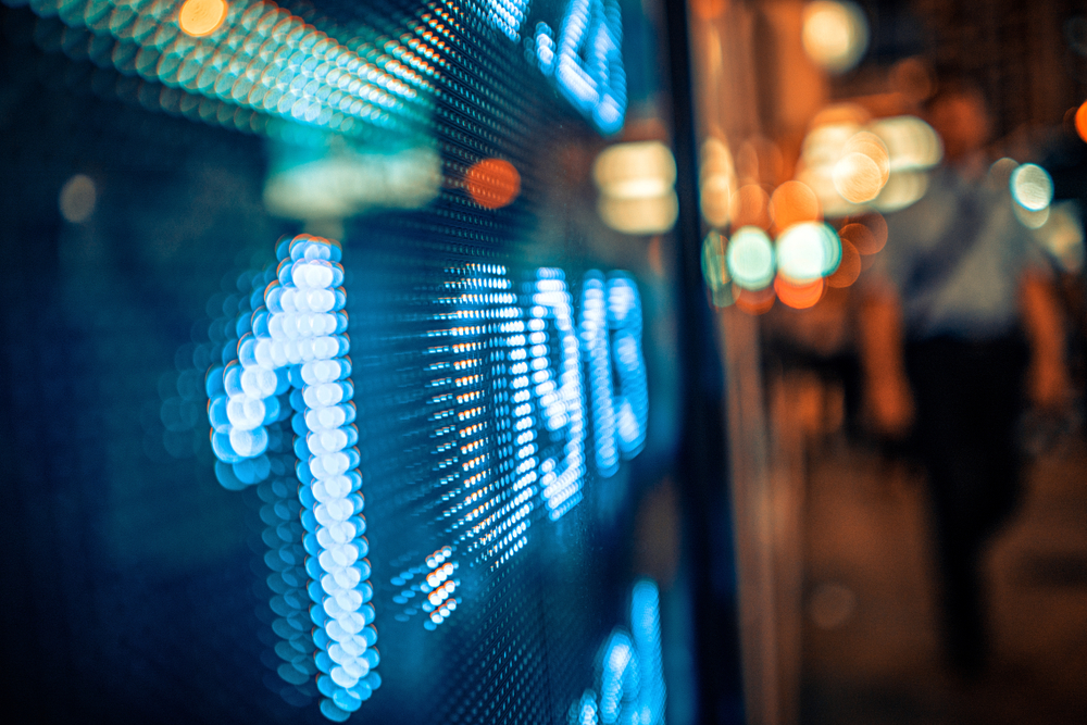 Display,Of,Stock,Market,Quotes,With,City,Scene,Reflect,On